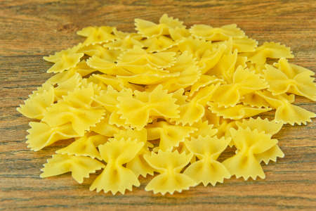 Pasta Bow on Wooden Background. Studio Photo