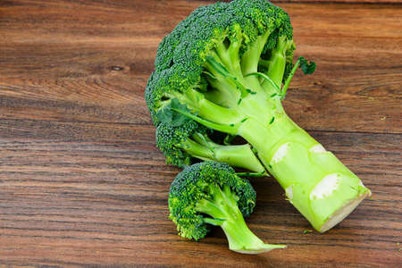 Fresh Juicy Green Broccoli on Wood Background Studio Photo