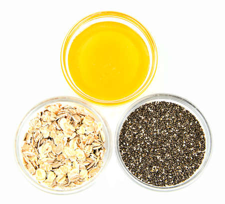 Chia Seeds, Oatmeal, Honey in Glass Bowl Isolated on White Background Studio Photoの写真素材