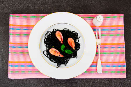 Black Spaghetti with Cuttlefish Ink, Prawns and Basil. Mediterranean and Asian Cuisine. Studio Photoの写真素材