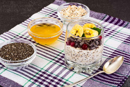 Chia Seeds, Oatmeal, Honey, Cranberries, Chocolate and Mint  in Glass Bowl Studio Photoの写真素材