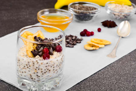 Chia Seeds, Oatmeal, Honey, Cranberries, Chocolate and Mint  in Glass Bowl Studio Photoの写真素材
