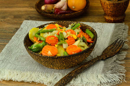 Steamed vegetables potatoes, carrots, corn, green beans and onion Studio Photoの写真素材