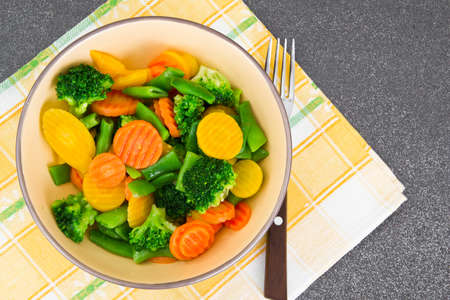 Steamed Vegetables Potatoes, Carrots, Corn, Green Beans and Onion Studio Photoの写真素材