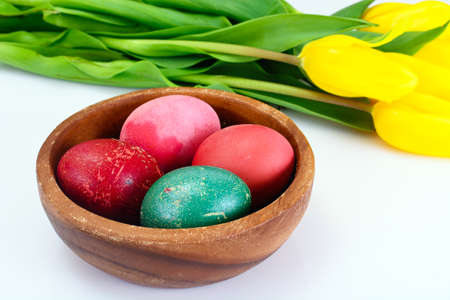 Painted Easter Eggs and Spring Yellow Tulips Flower Studio Photoの写真素材