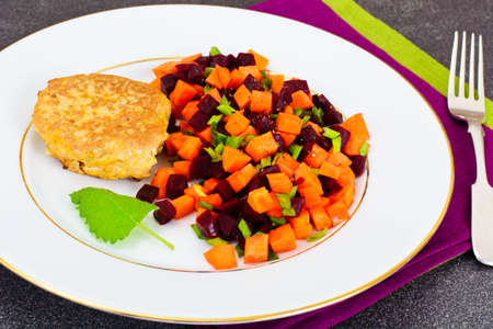 Fish Cutlet with a Salad of Carrots and Beets. Studio Photoの写真素材