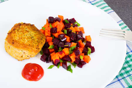 Fish Cutlet with a Salad of Carrots and Beets. Studio Photoの写真素材