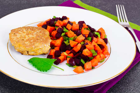 Fish Cutlet with a Salad of Carrots and Beets. Studio Photoの写真素材