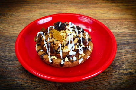 Homemade Cakes: Cake on Plate with Nuts, Chocolate and Raisins. Studio Photo
