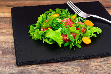 Juicy Fresh Green Salad of Lettuce, Arugula, Gapefruit and Kumquats Studio Photo