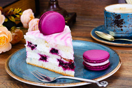 Sweet and Colourful Cake with French Macaroons with Cup of Cofee. Studio Photo