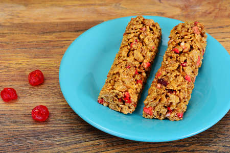 Muesli bars with sunflower seeds, nuts and dried cherrieson Wood Studio Photo