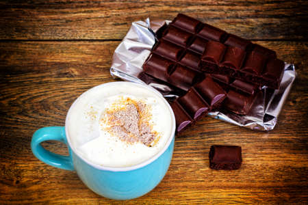 Coffee with milk, cappuccino in a blue retro cup. Studio Photo