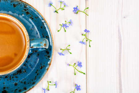 Coffee  in a blue retro cup with Flowers. Studio Photoの写真素材