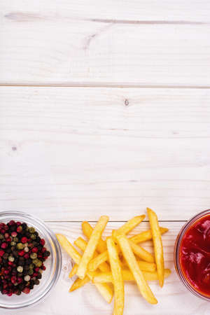 French Fries with Ketchup on Wood. Studio Photo