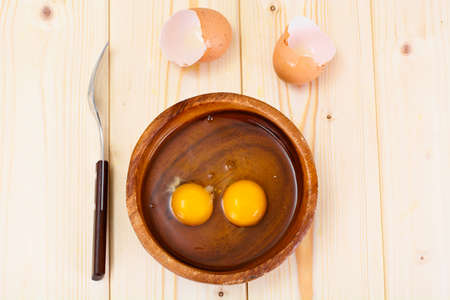 Raw Eggs on Wood Plate Studio Photo
