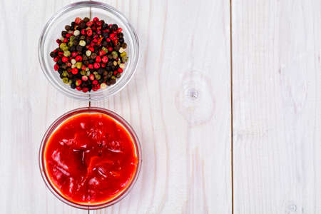 Ketchup, a Mix of Peppers on a Wood Board Background Studio Photoの写真素材