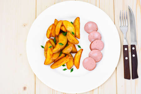 Fried Potato Wedges in a Rural and Sausage Studio Photoの写真素材