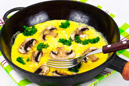 Healthy and Diet Food: Scrambled Eggs with Mushrooms and Vegetables. Studio Photo