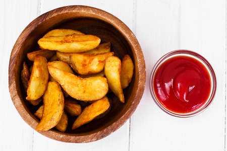 Potato Wedges, Potatoes in a Rural with Tomato Ketchup Studio Photo