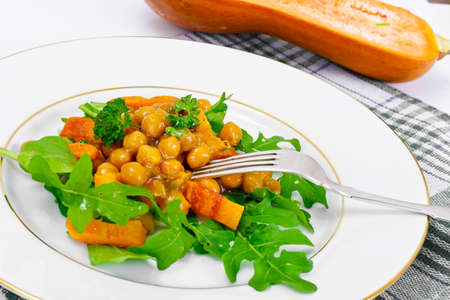 Salad with Chickpeas in a Curry Sauce, Arugula, Grilled Pumpkin and Cherry Tomato Studio Photoの写真素材