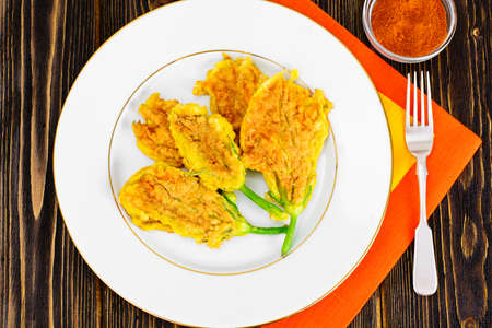 Flowers of Zucchini, Fried in Batter on a Wooden Background Studio Photoの写真素材