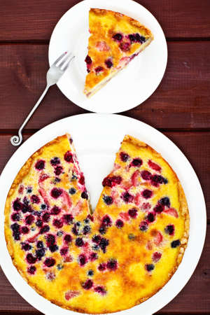 Cake with Strawberries, Blueberries, Currants and Raspberries, Creme Brulee on Rustic Boards Studio Photoの写真素材