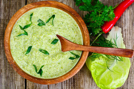 Soup Cream of Lettuce in a Wooden Bowl Studio Photoの写真素材