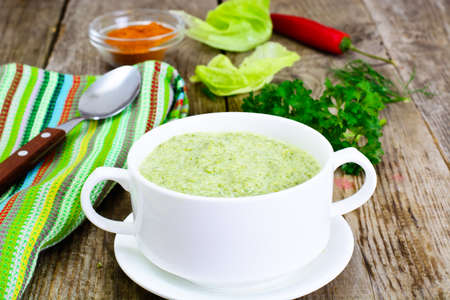 Soup Cream of Lettuce in a Wooden Bowl Studio Photoの写真素材