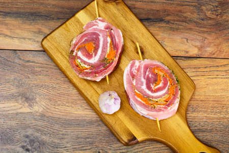 Roll of Bacon with Mushrooms, Carrots, Greens, Barbecue Grill. Studio Photoの写真素材