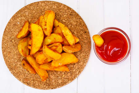 Potato Wedges, Potatoes in a Rural with Tomato Ketchup Studio Photoの写真素材