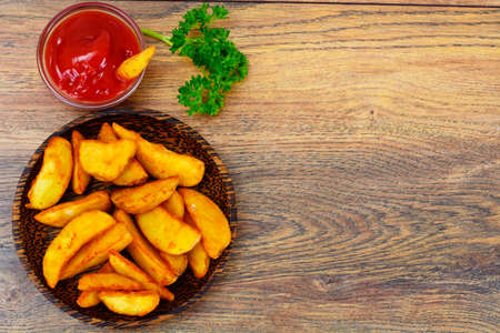 Potato Wedges, Potatoes in a Rural with Tomato Ketchup Studio Photoの写真素材