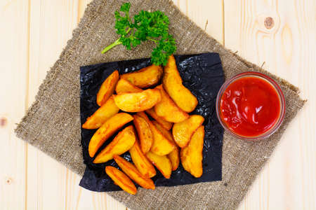Potato Wedges, Potatoes in a Rural with Tomato Ketchup Studio Photoの写真素材