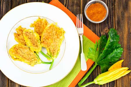 Flowers of Zucchini, Fried in Batter on a Wooden Background Studio Photoの写真素材