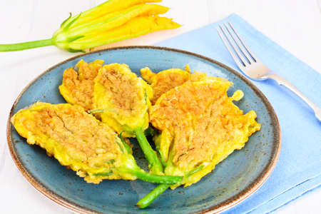 Flowers of Zucchini, Fried in Batter on a Wooden Background Studio Photoの写真素材