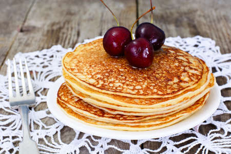 Tasty Pancakes Stack with Honey and Cherry Studio Photoの写真素材