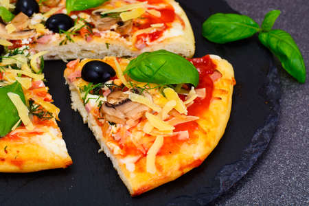 Pizza with Mushroom, Cheese, Mozzarella, Olives and Basil Studio Photoの写真素材