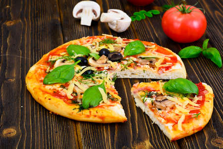 Pizza with Mushroom, Cheese, Mozzarella, Olives and Basil Studio Photoの写真素材