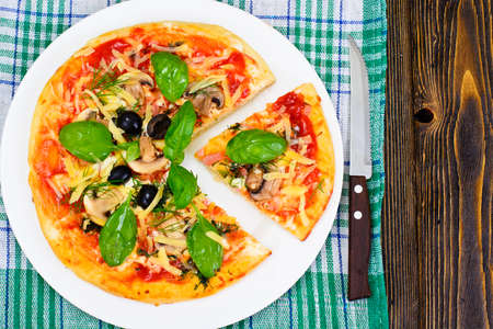 Pizza with Mushroom, Cheese, Mozzarella, Olives and Basil Studio Photoの写真素材