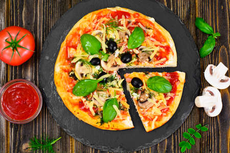 Pizza with Mushroom, Cheese, Mozzarella, Olives and Basil Studio Photoの写真素材