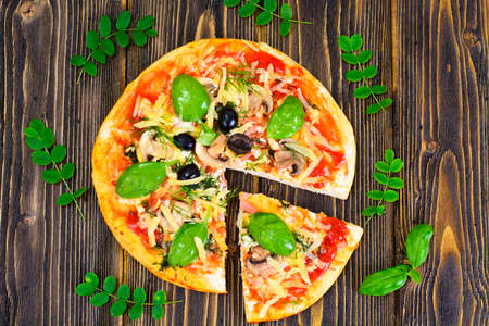 Pizza with Mushroom, Cheese, Mozzarella, Olives and Basil Studio Photoの写真素材
