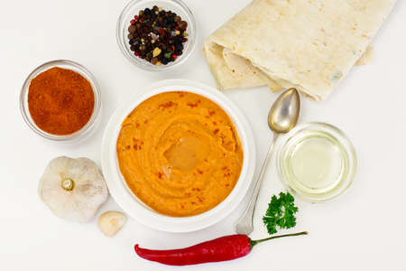 Hummus with Curry, Turmeric, Raw Chickpeas on the White Background Studio Photoの写真素材