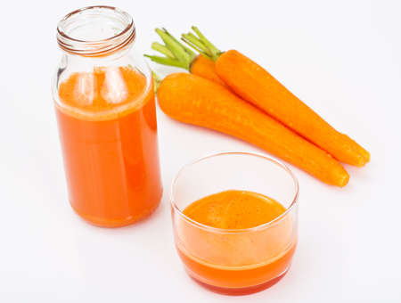 Fresh Juicy Orange Carrots and Juice Studio Photoの写真素材