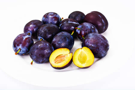 Juicy Ripe Plums on White Background Studio Photoの写真素材