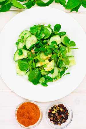 Salad with Cucumber, Purslane and Green Peas on Dark Disks Studio Photoの写真素材