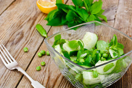 Salad with Cucumber, Purslane and Green Peas on Dark Disks Studio Photoの写真素材