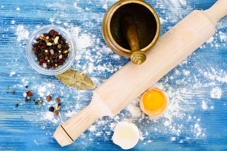 Flour, Eggs and Rolling Pin on a Blue Background Studio Photoの写真素材