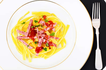 Noodles with Salami on White Plate Studio Photoの写真素材