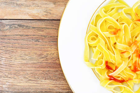 Noodles with Salami on White Plate Studio Photoの写真素材