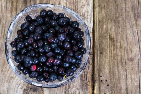 Bilberry in Crystal Bowl on Rustic Wooden Background